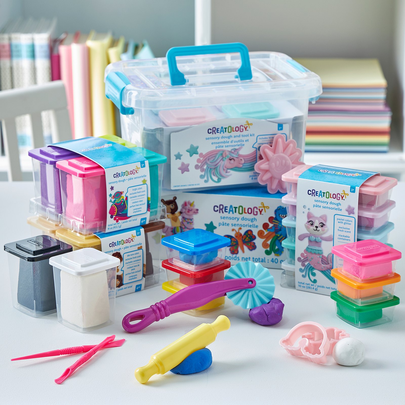 Creatology craft supplies spread across a work table