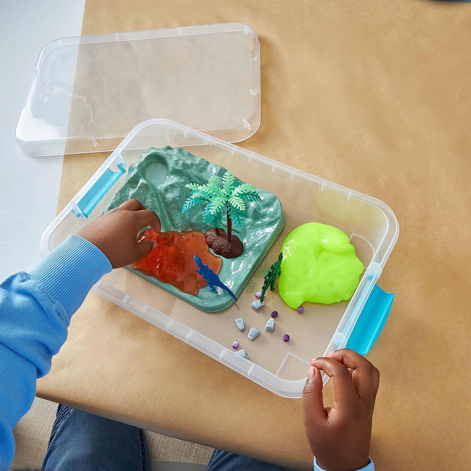 Child mixing slime from a Creatology activity kit